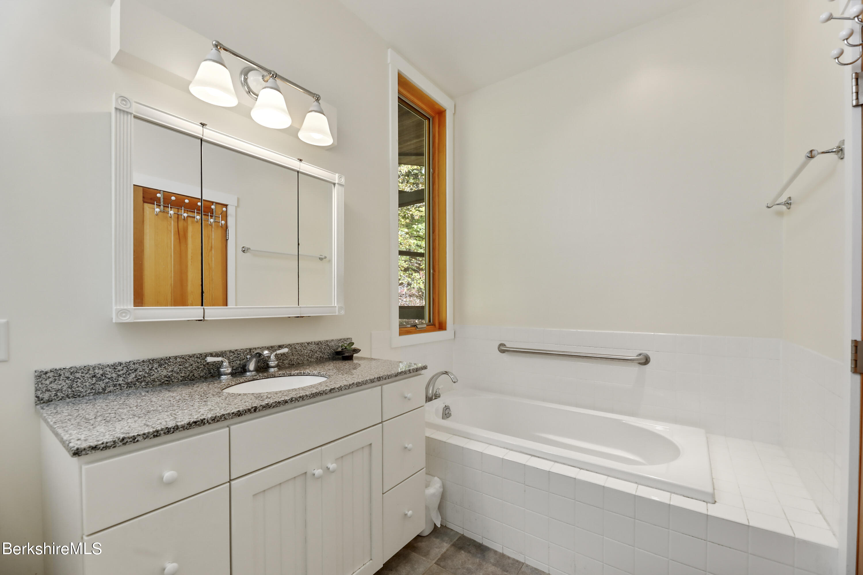 494 Dean Hill Road Richmond, MA 01254 - Photo 29 of 54 a bathroom with a granite countertop sink mirror and a bathtub