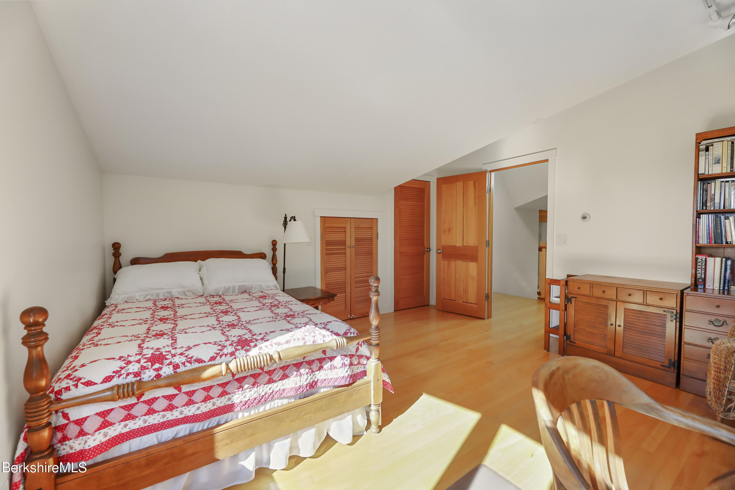 494 Dean Hill Road Richmond, MA 01254 - Photo 33 of 54 a bedroom with a bed and wooden floor