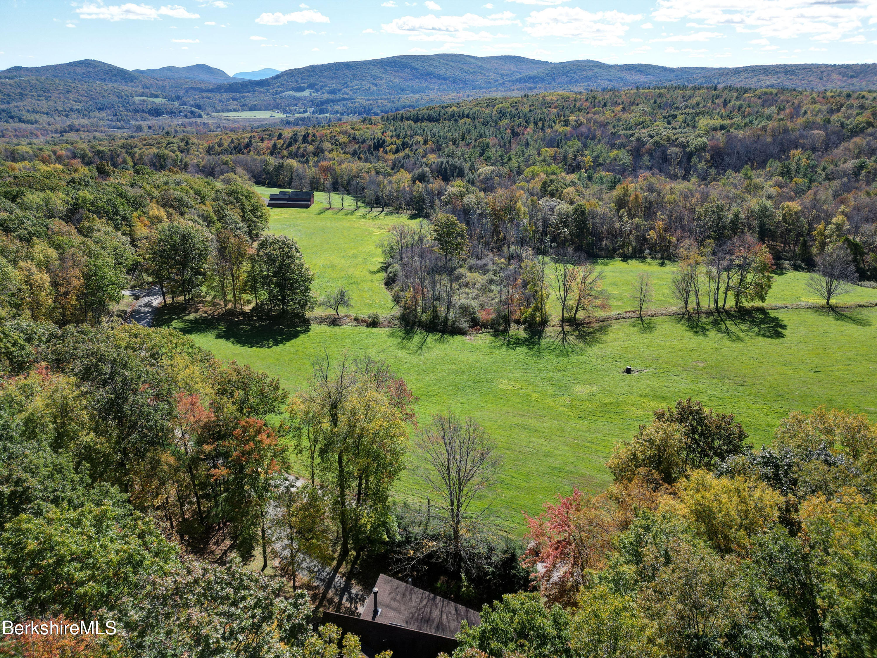 494 Dean Hill Road Richmond, MA 01254 - Photo 5 of 54 a view of a lush green hillside and houses