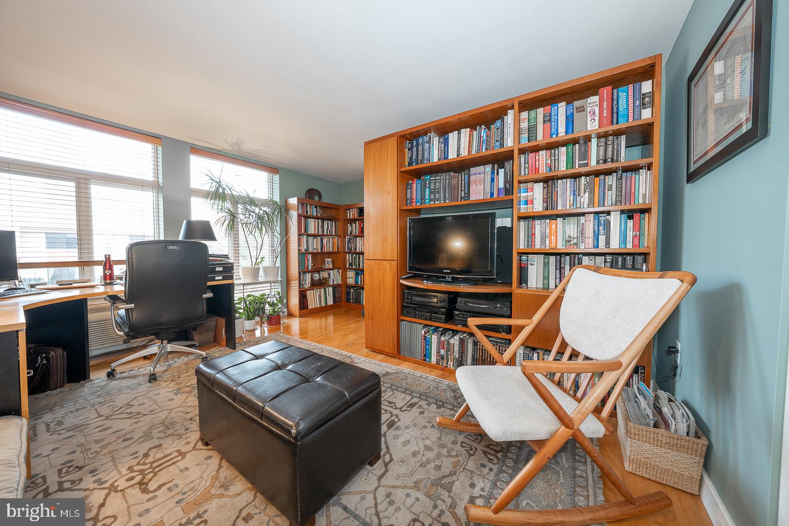 1900 Hamilton Street, Unit D19 Philadelphia, PA 19130 - Photo 25 of 41 a living room with furniture a flat screen tv and a floor to ceiling window