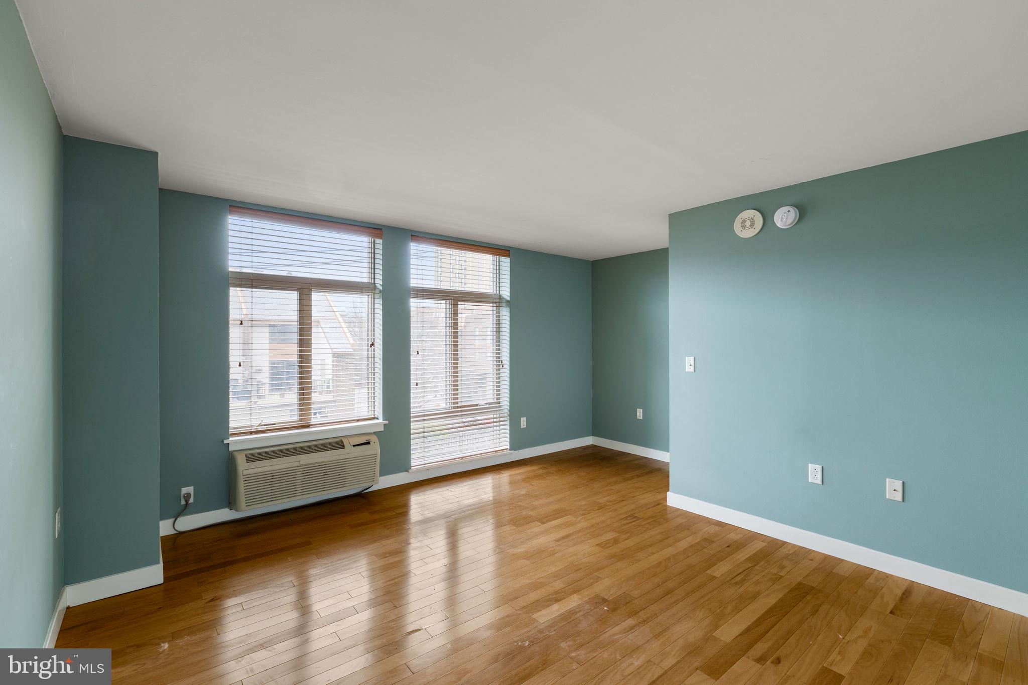 1900 Hamilton Street, Unit D19 Philadelphia, PA 19130 - Photo 28 of 41 an empty room with wooden floor and windows