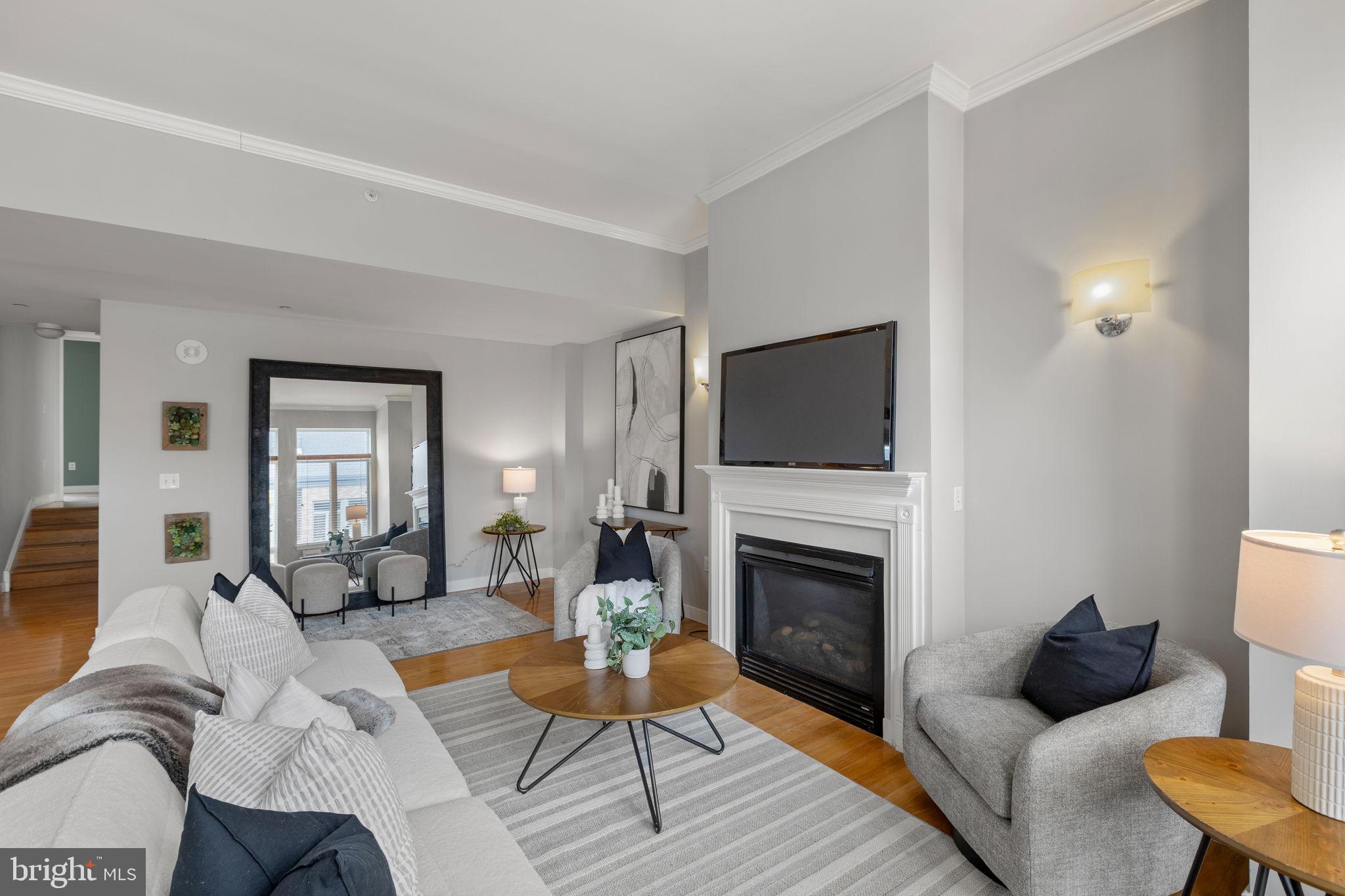 1900 Hamilton Street, Unit D19 Philadelphia, PA 19130 - Photo 5 of 41 a living room with furniture a flat screen tv and a fireplace