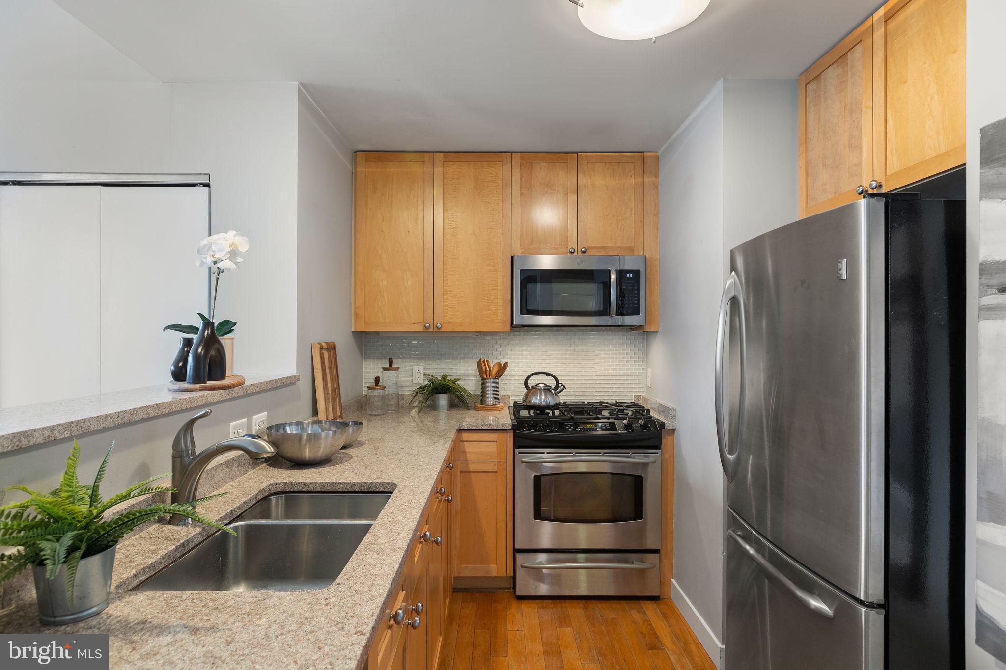 1900 Hamilton Street, Unit D19 Philadelphia, PA 19130 - Photo 8 of 41 a kitchen with a sink stove and refrigerator
