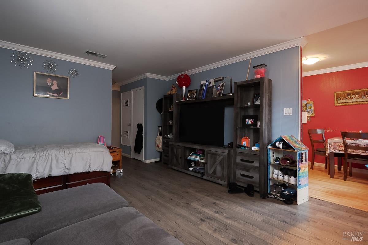 22 Fairfax Street, Unit E San Rafael, CA 94901 - Photo 3 of 7 a bedroom with furniture and a flat screen tv