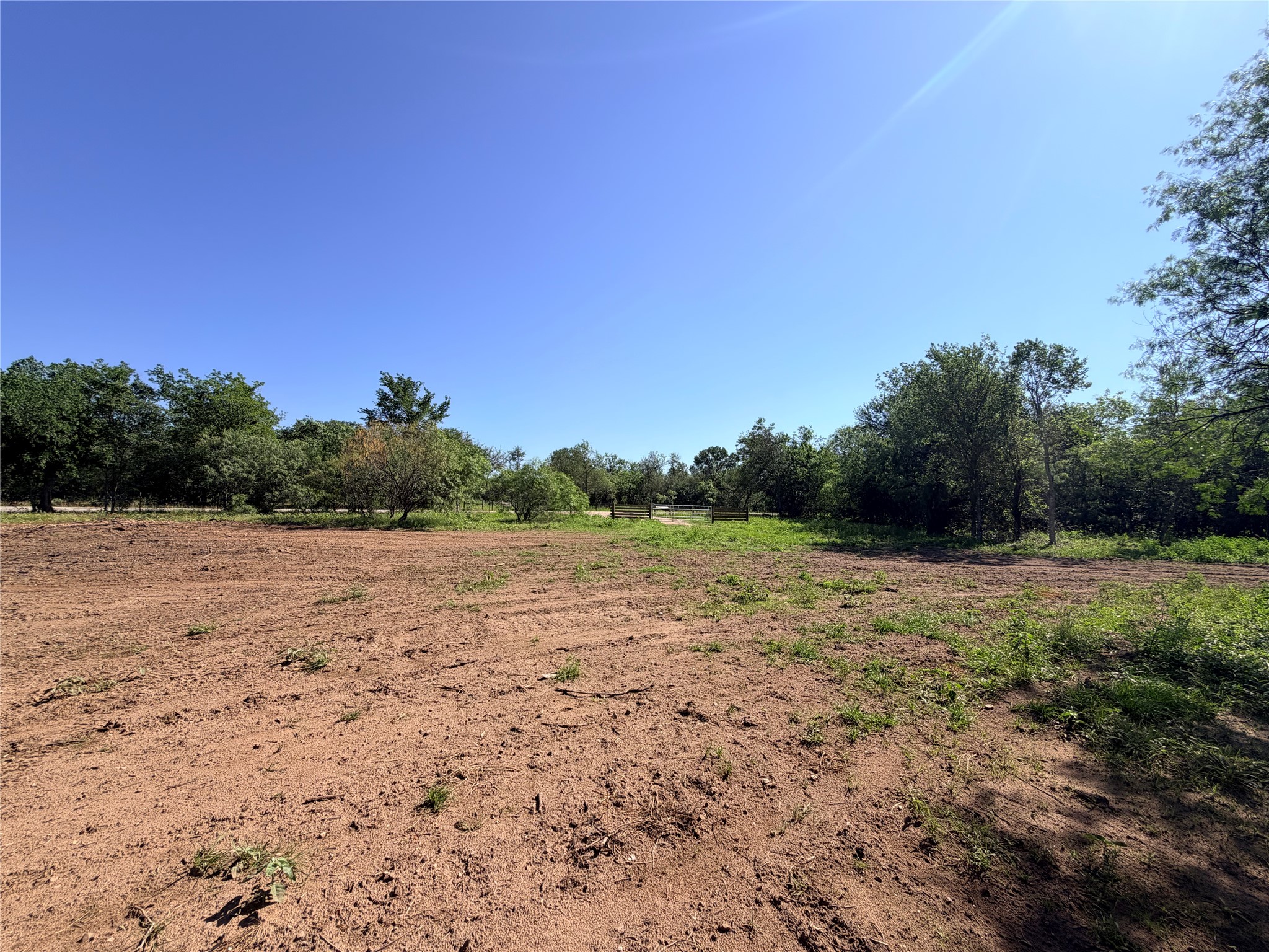 150 Pumper Road Luling, TX 78648 - Photo 22 of 24 A spacious, cleared lot bordered by verdant trees offers a blank canvas for development.