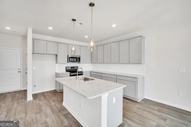 a kitchen with a sink a stove a refrigerator and a window