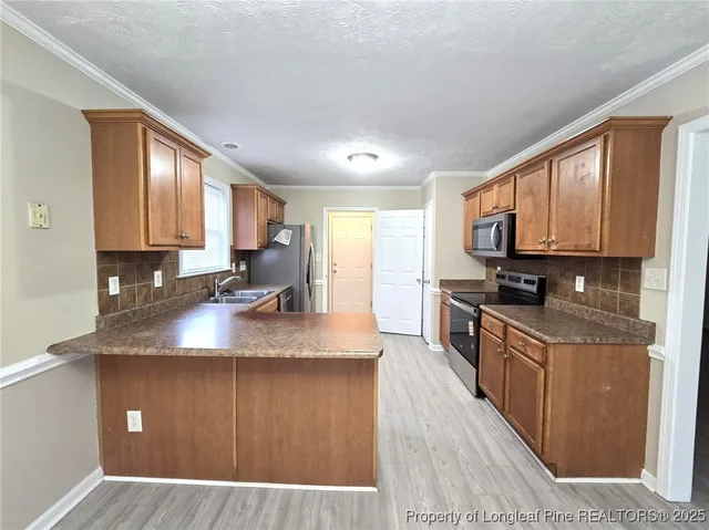 a kitchen with kitchen island granite countertop a sink window and cabinets