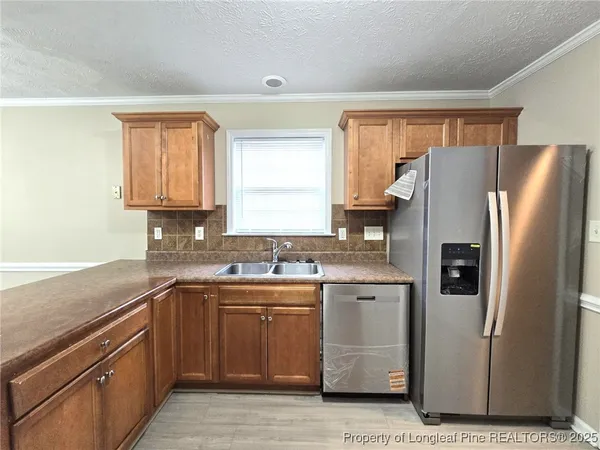 a kitchen with a sink stove and refrigerator
