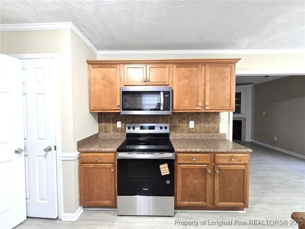 a kitchen with a stove and a microwave