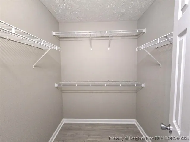 a view of storage and utility room with racks on the wall
