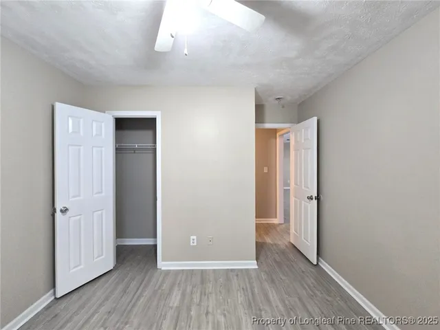 a view of a hallway with wooden floor