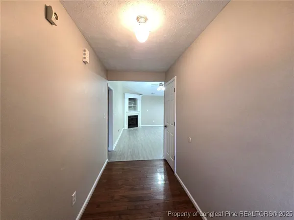 a view of hallway with wooden floor