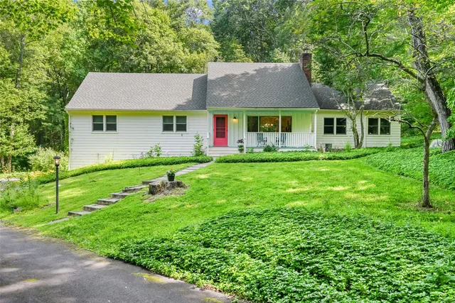 a front view of house with yard and green space