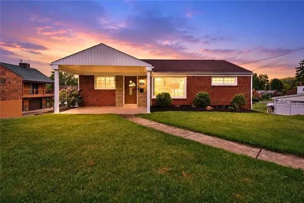 a front view of a house with a yard