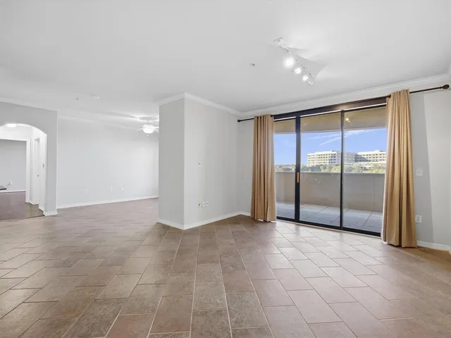 a view of an empty room with glass door