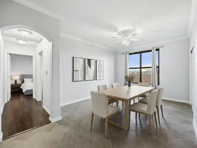 a view of a dining room with furniture and a chandelier