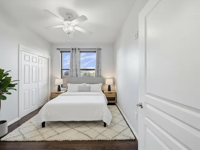 a bedroom with a large bed and a window