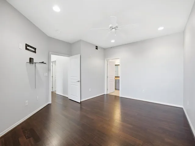 a view of an empty room with wooden floor