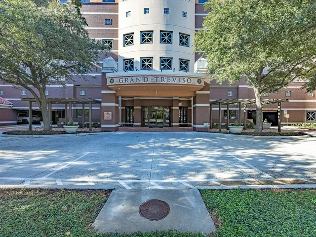 a tall building with large trees