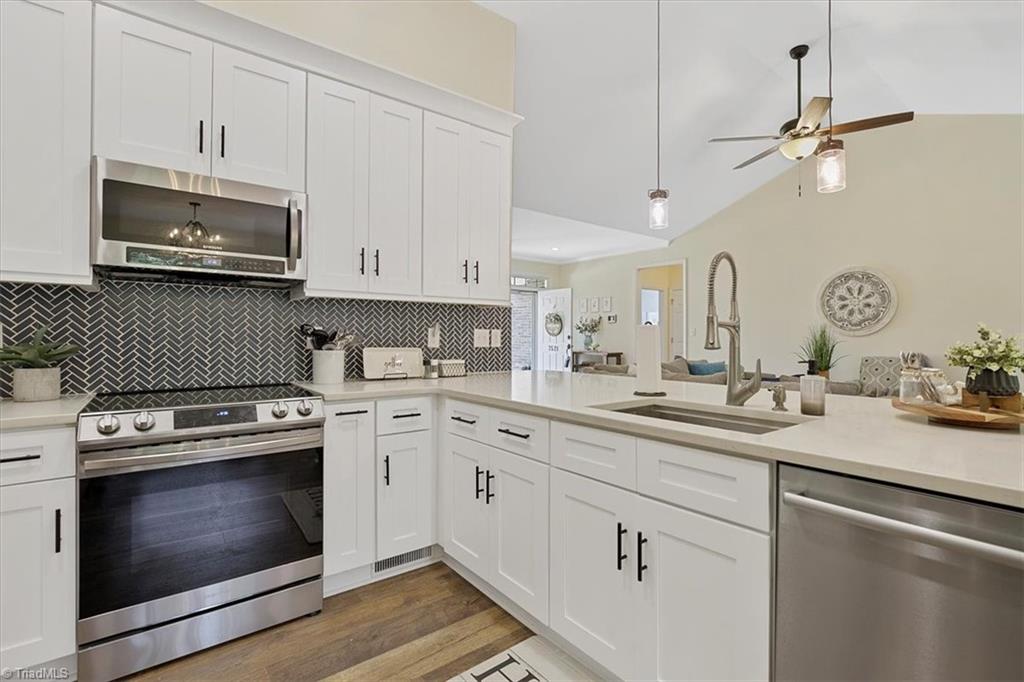 7521 Kristen Drive Oak Ridge, NC 27310 - Photo 11 of 34 All New SS appliances and check out the exquisite herringbone tile patterned backsplash!