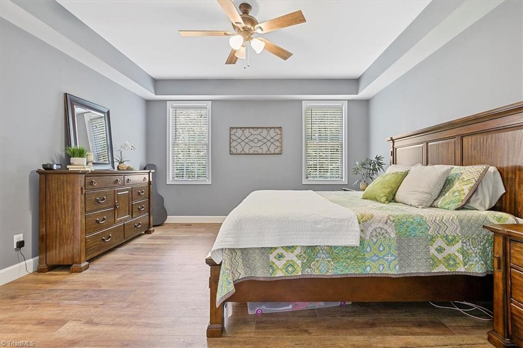 7521 Kristen Drive Oak Ridge, NC 27310 - Photo 18 of 34 Primary bedroom with trey ceiling overlooks backyard