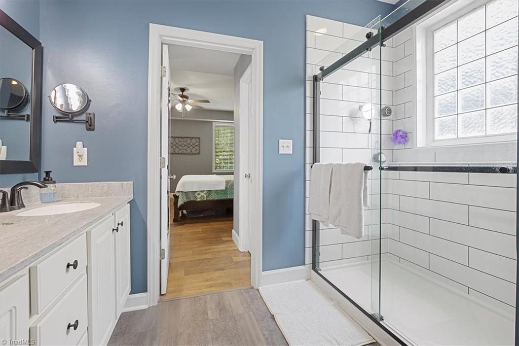 7521 Kristen Drive Oak Ridge, NC 27310 - Photo 20 of 34 Newly remodeled Owners Suite bath with stunning designer look walk in tile shower