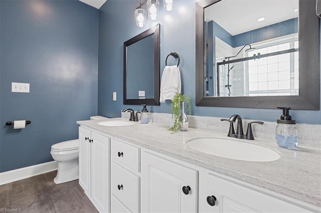 7521 Kristen Drive Oak Ridge, NC 27310 - Photo 22 of 34 New Dual vanity, faucets, cabinets, mirrors, and Lighting