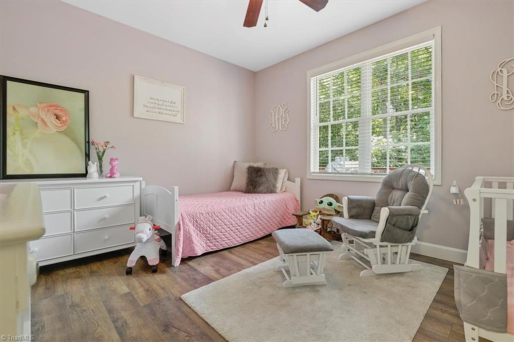 7521 Kristen Drive Oak Ridge, NC 27310 - Photo 23 of 34 Large bedroom overlooks the wooded backyard space
