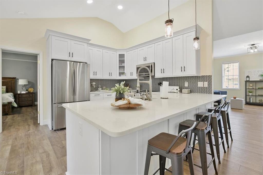 7521 Kristen Drive Oak Ridge, NC 27310 - Photo 10 of 34 Brand new custom cabinetry! New counters and new backsplash!