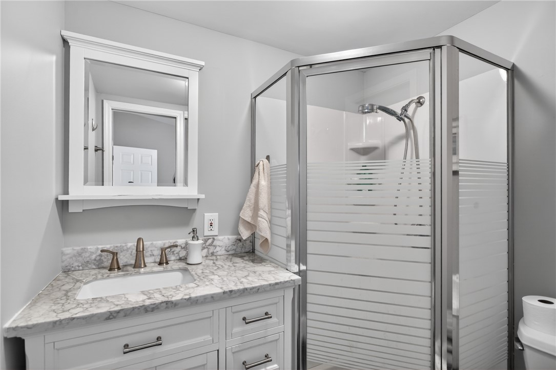 1230 Melton Road, Unit 4 West Union, SC 29696 - Photo 21 of 48 A corner shower enclosure and a vanity with a sleek countertop create a modern and practical bathroom space.