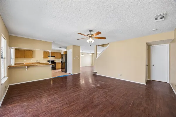 a view of a kitchen with wooden floor and a kitchen