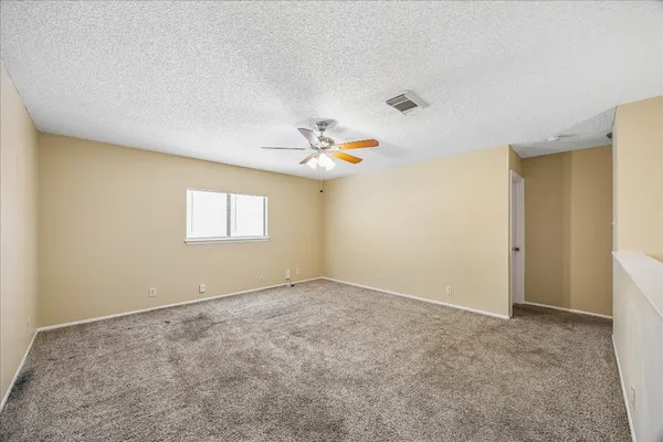 a view of a livingroom with a chandelier fan