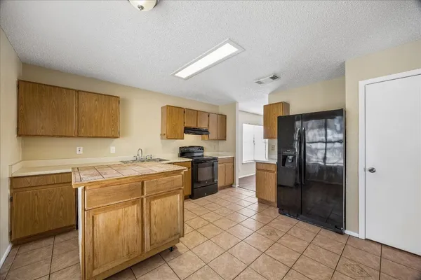 a kitchen with a sink cabinets and wooden floor