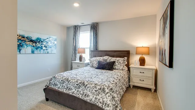 a bedroom with a bed and a painting on the wall