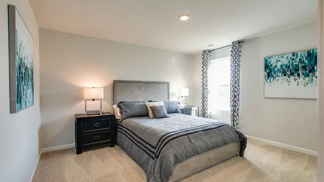 a bedroom with a bed and a painting on the wall