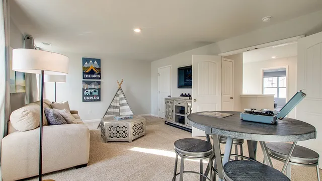 a living room with furniture a table and a flat screen tv