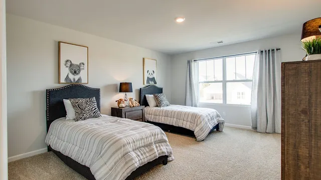 a bed room with two beds and a window