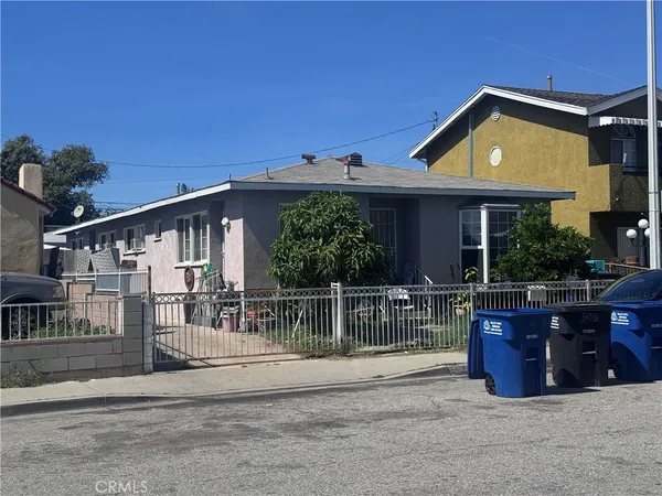 a front view of house with a garden