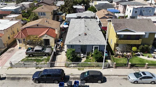 an aerial view of a houses with yard and street view