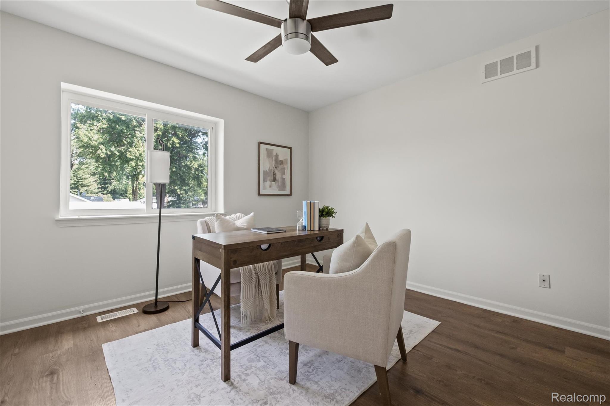 4427 Hannan Road Wayne, MI 48184 - Photo 12 of 33 Bright room featuring a large window, wood-finish flooring, a ceiling fan, and light-colored walls