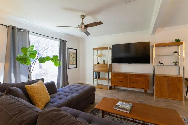 a living room with furniture and a flat screen tv