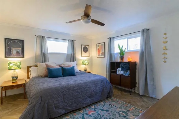 a bedroom with a bed and a chandelier