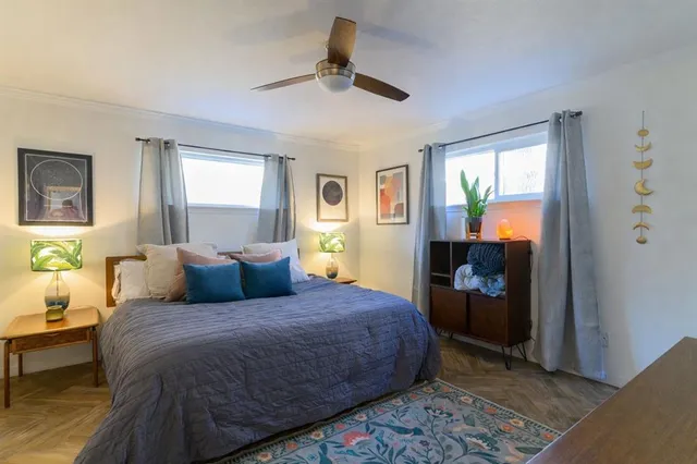 a bedroom with a bed and a chandelier