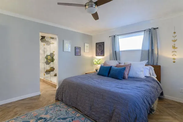a bedroom with a large bed and a window