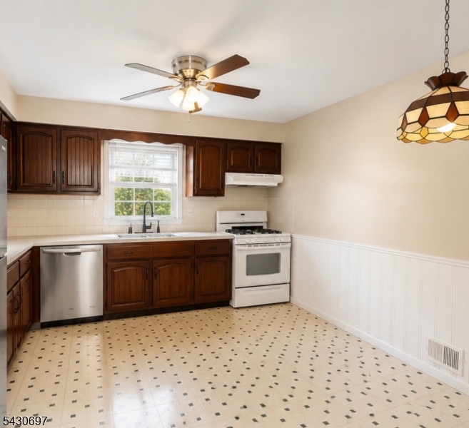 2479 Dayton Avenue Union, NJ 07083 - Photo 4 of 9 a kitchen with a stove a sink and a microwave