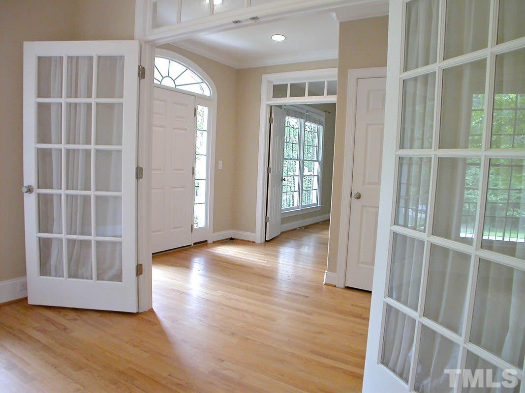 5409 Levering Mill Road Apex, NC 27539 - Photo 5 of 22 an empty room with wooden floor and windows