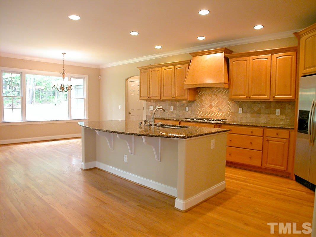 5409 Levering Mill Road Apex, NC 27539 - Photo 8 of 22 a kitchen with stainless steel appliances granite countertop a stove a sink and a refrigerator