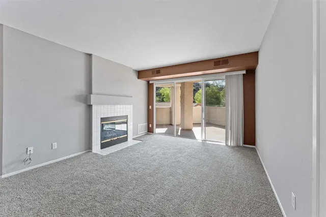 a view of empty room with a fireplace
