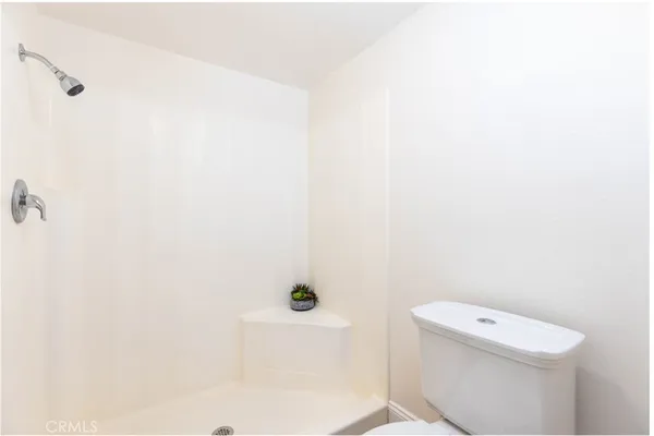 a white toilet sitting next to a white sink