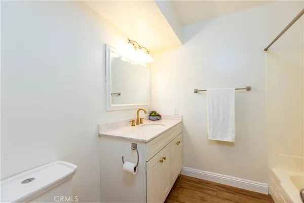 a bathroom with a sink toilet and mirror